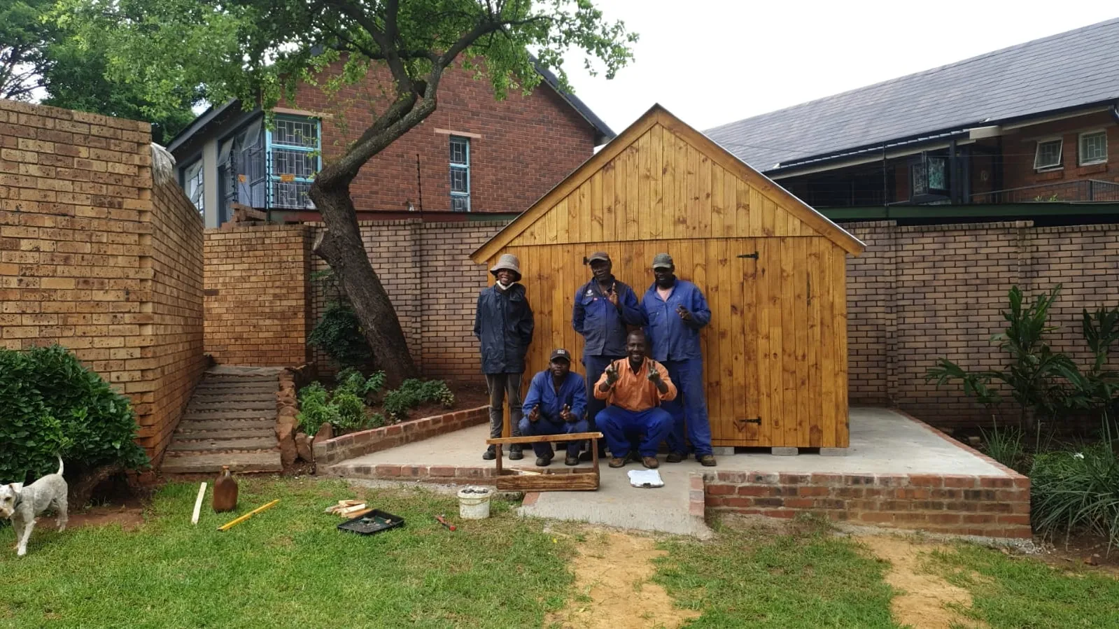 The A&H team standing in front of a freshly built timber shed on a new concrete base